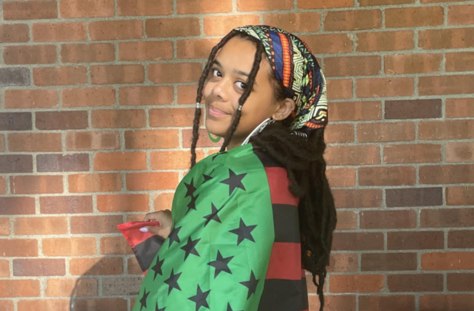 Girl wrapped in pan african flag